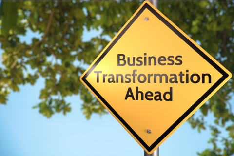 Photo of yellow diamond shaped road sign with the words Business Transformation Ahead. Explains what LINQ does.
